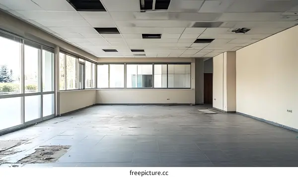 Empty Office Space with Damaged Ceiling and Floor