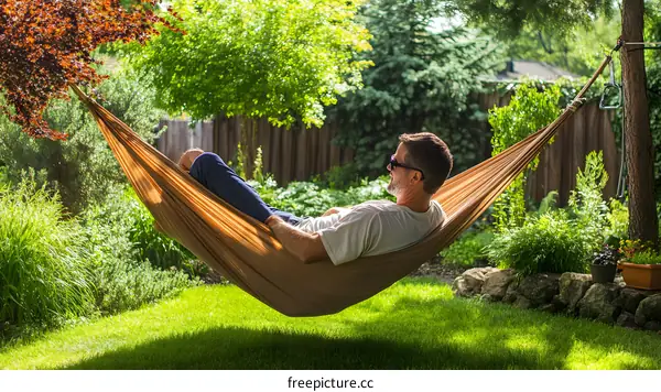 Man Relaxing in a Hammock in a Backyard Garden