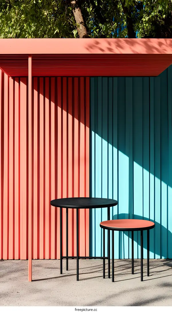 Two Round Tables with Black Legs and Colorful Striped Wall Background