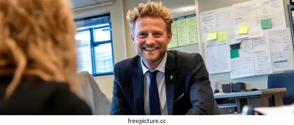 Smiling Man in Suit Meeting With a Woman in Office