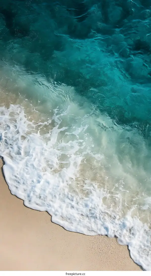 Ocean Wave Crashing On Sandy Beach