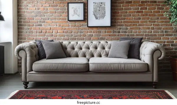 Stylish Light Gray Chesterfield Sofa in a Brick Wall Living Room