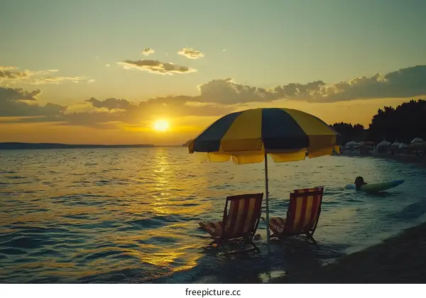 Sunset Beach with Two Chairs and Umbrella