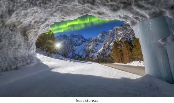 Snow Cave View of Mountain Range with Aurora Borealis