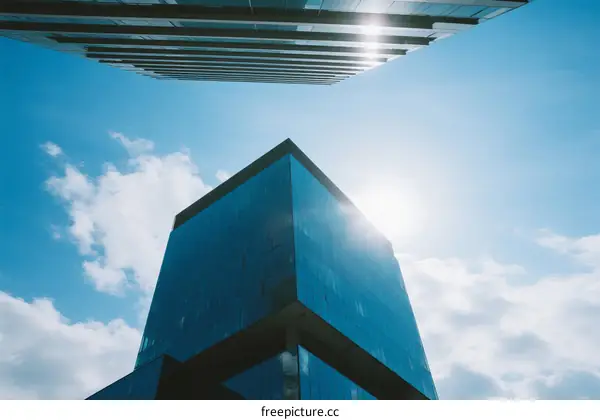 Modern skyscraper under clear blue sky with sunlight shining