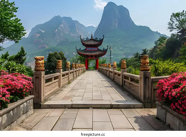Stone Bridge Leading to Chinese Pagoda in Mountain Landscape