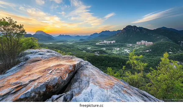 Mountaintop View at Sunrise with Cityscape