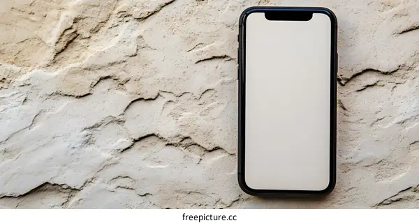 Black Smartphone on a White Stone Wall