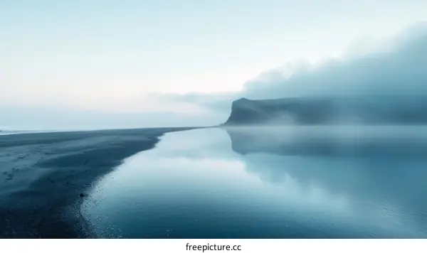 Foggy Icelandic Beach with Distant Mountain