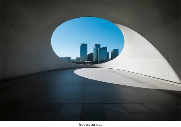 Oval-shaped architectural structure with city skyline view