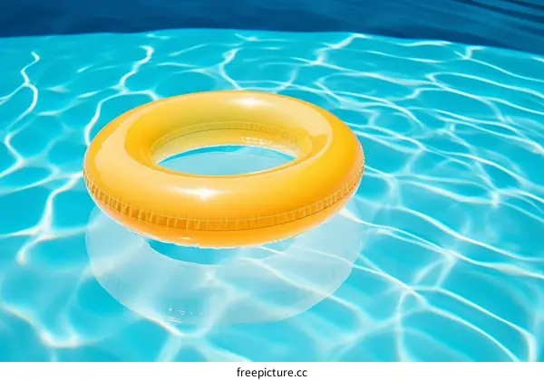 Orange life ring floating in a blue swimming pool