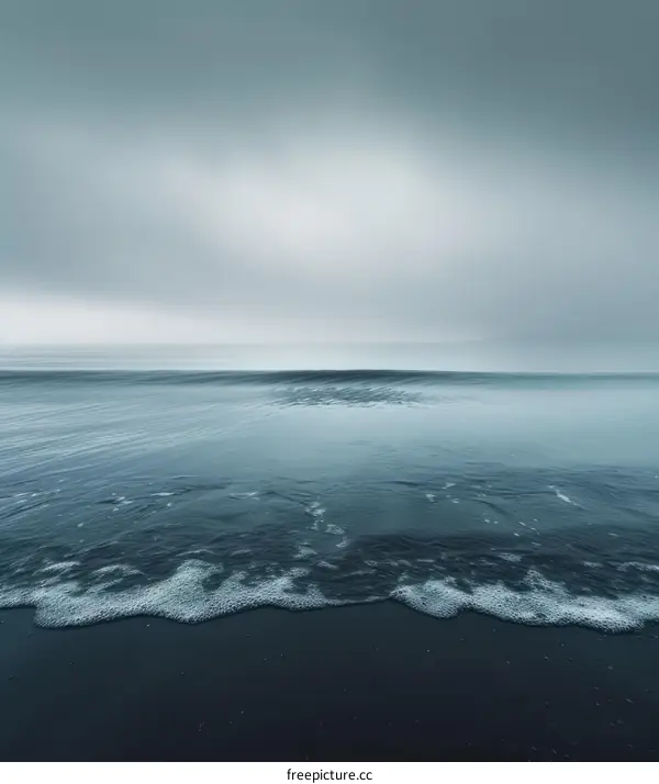 Dark and moody seascape with a wave crashing on the shore