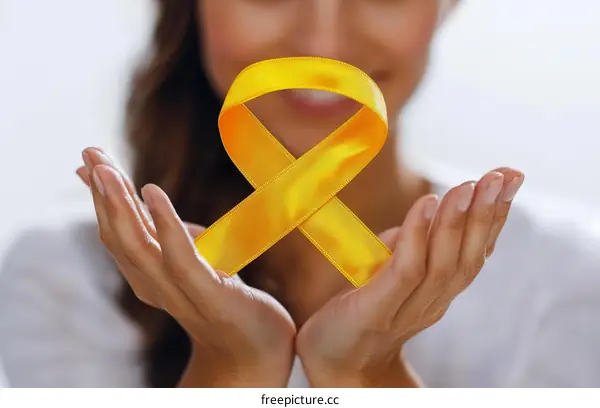 Woman Holding a Yellow Awareness Ribbon
