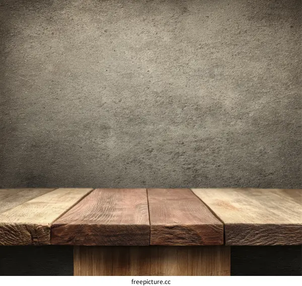 Wooden Tabletop Against a Rustic Gray Concrete Wall Background