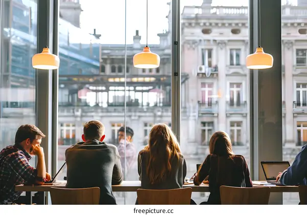 People Working in a Coffee Shop With a City View