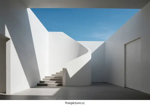 Spiral Staircase in Minimalist White Building Under Blue Sky