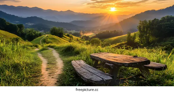 Sunrise Over Mountain Landscape With Wooden Bench