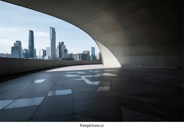 Modern city skyline view from a curved concrete structure
