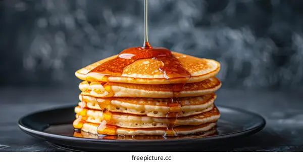 Stack of Pancakes Drizzled with Sweet Syrup