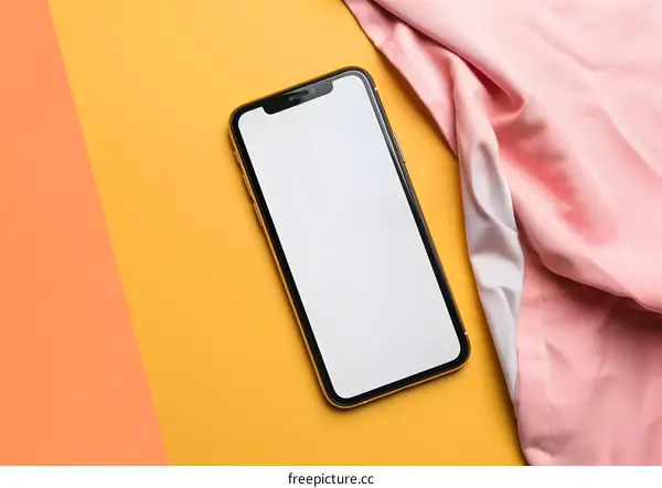 Blank Screen Smartphone on Yellow Background with Pink Fabric