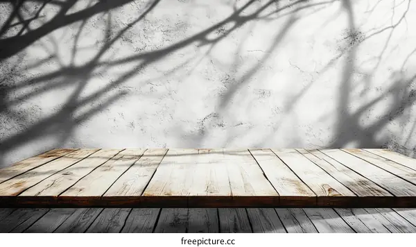 Wooden Table Top with Tree Branch Shadows on Gray Wall
