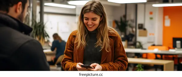 Smiling Woman Using Phone in Office Setting