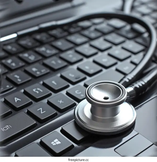 A stethoscope rests on a laptop keyboard
