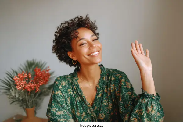 Smiling Woman Wearing Green Dress Waving Hand