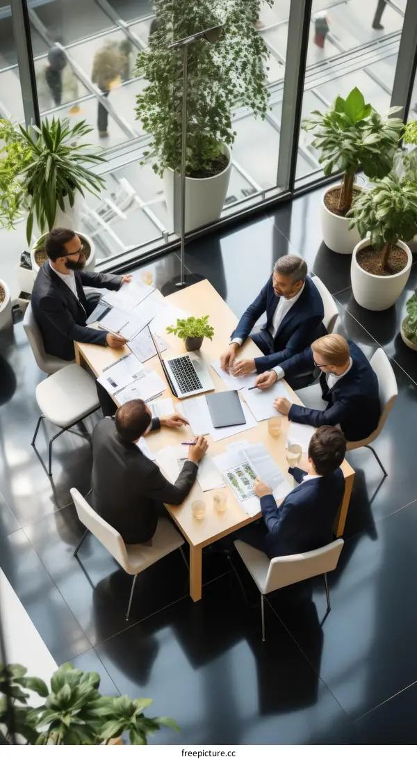 Top view of business people having a meeting around a table in a modern office