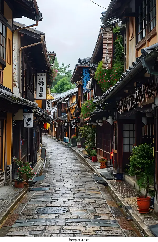 An empty narrow stone street in Japan with traditional houses on both sides