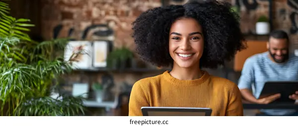 Smiling African American Woman Using a Tablet in Office