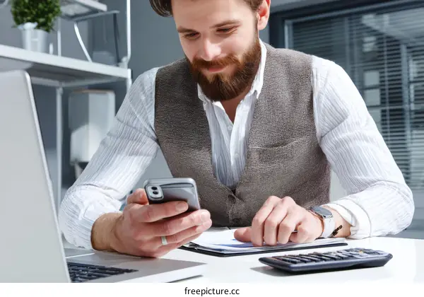 Businessman using a smartphone in office