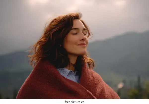 Woman Enjoying Mountain Scenery Wrapped in a Warm Blanket
