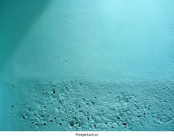 Teal-colored textured wall surface