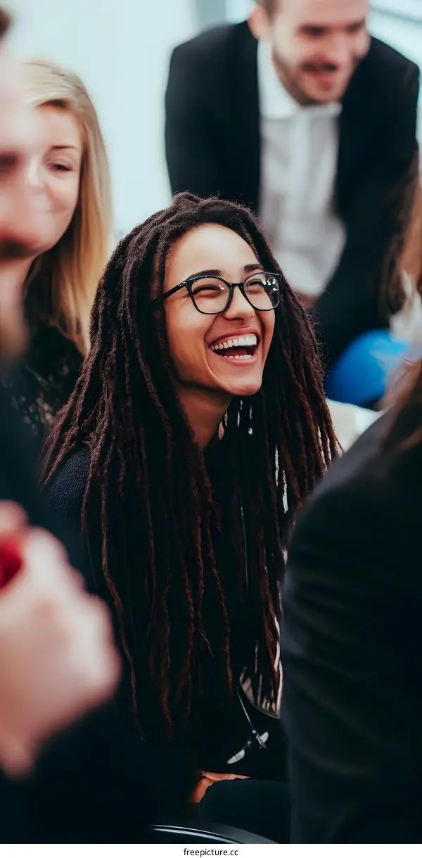 Woman With Dreads Smiling During a Meeting