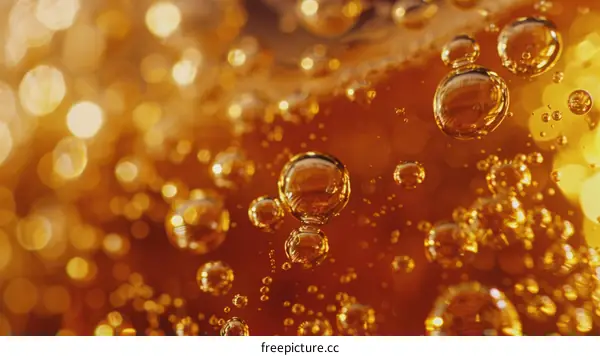 Close-up of Golden Bubbles in Amber Liquid