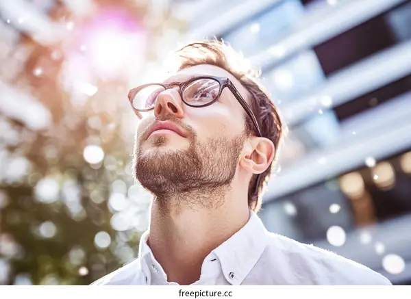 Man Looking Upward in City Setting