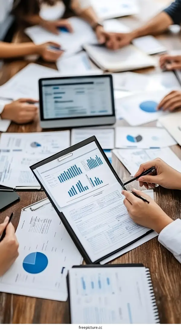 Business Meeting with Multiple People Analyzing Data