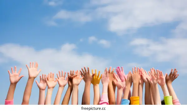 Children raising their hands in the air