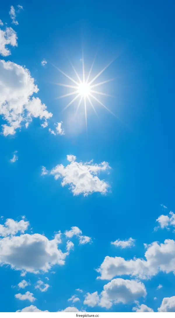 Blue sky with white clouds and shining sun