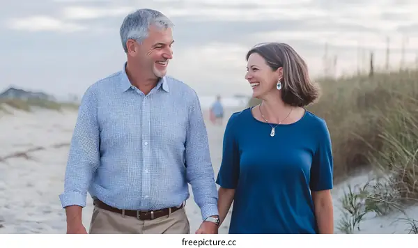 Happy Couple Walking on the Beach Holding Hands