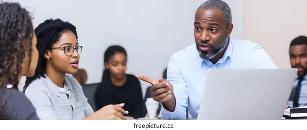 African American Businessman Leading a Group Meeting
