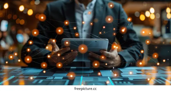 Businessman using a tablet with glowing network connections in the background