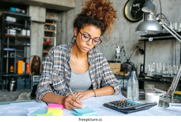 Young Woman Focused on Work in a Creative Space