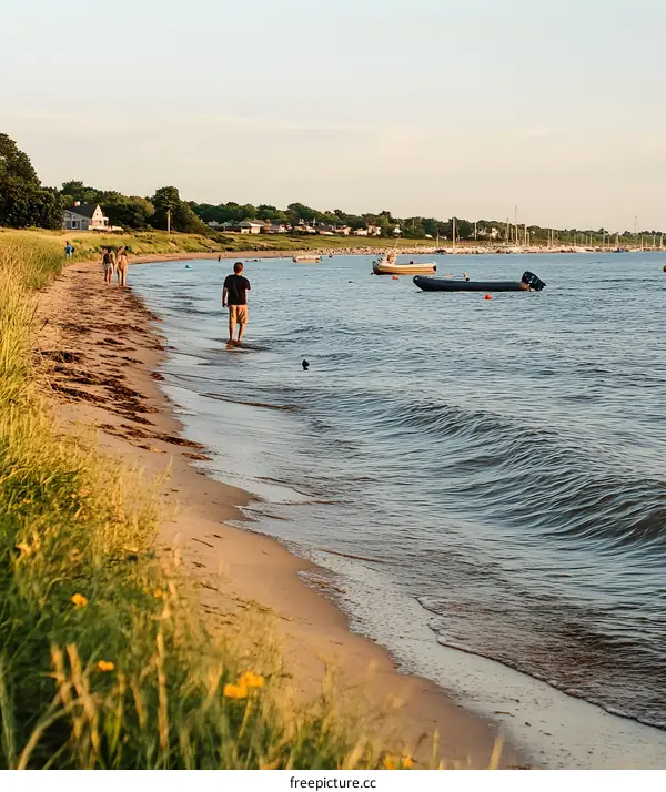 Peaceful Sunset Walk on a Sandy Beach with Boats in the Distance