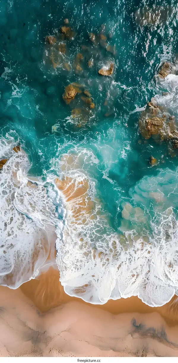 Aerial View of Ocean Waves Crashing on Sandy Beach