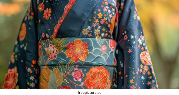 Close up of a woman wearing a kimono with floral embroidery