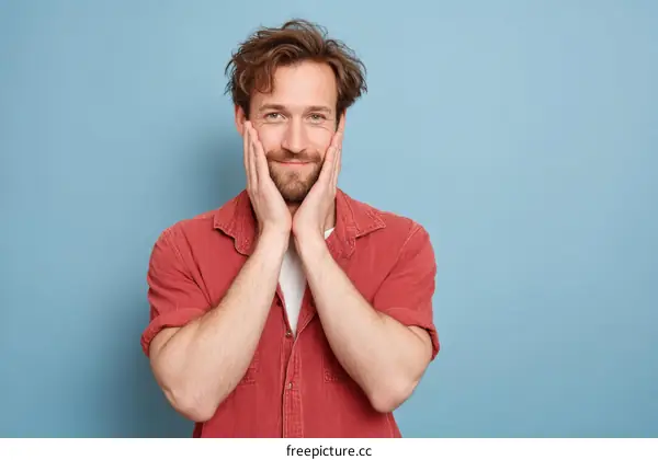 Handsome Man Touching his Face with a Happy Expression