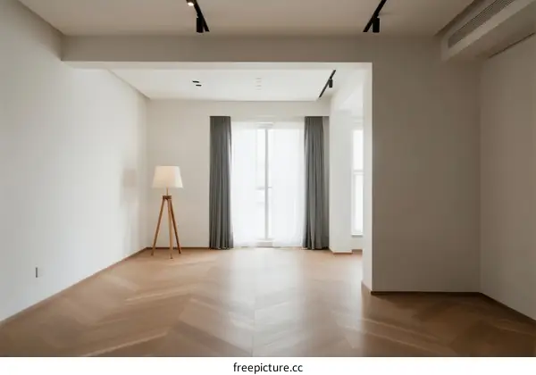 Bright and spacious empty room with wooden floor and large windows