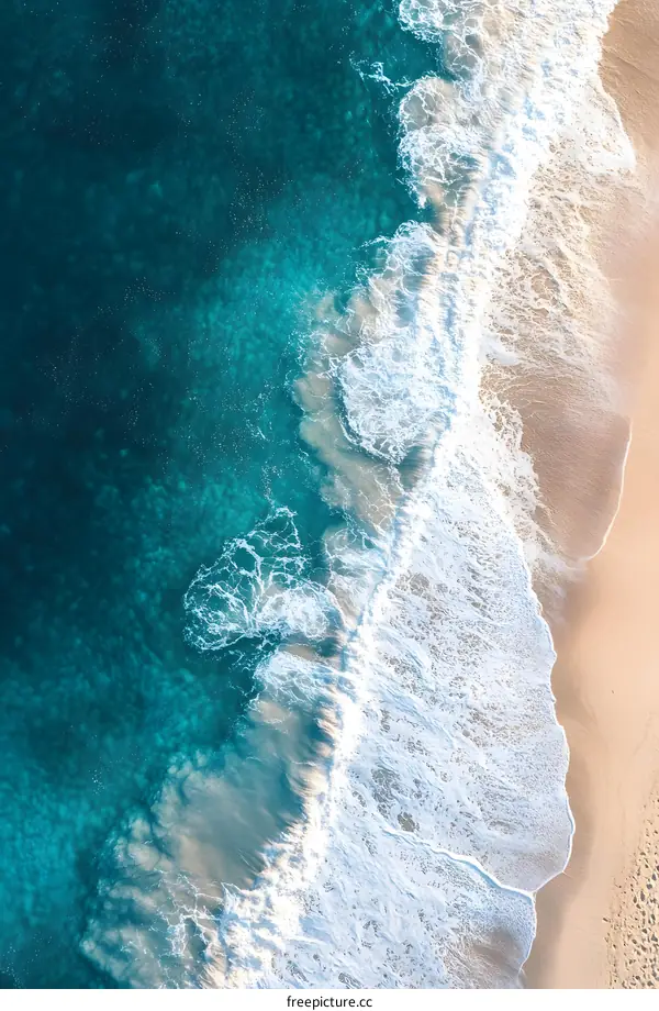 Aerial View of the Ocean Waves Crashing on the Beach